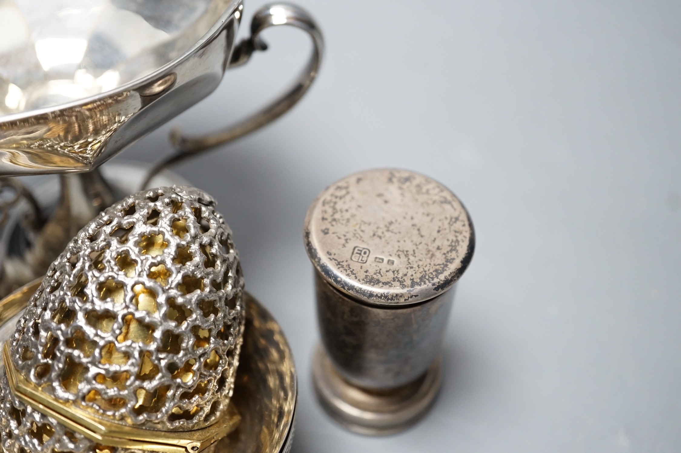 Small silver including Edwardian two handled pedestal bowl, Goldsmiths & Silversmiths Co Ltd, London, 1907, 97mm, a later silver tea strainer on stand, four Egyptian white metal finger bowls, a George VI communion set, L